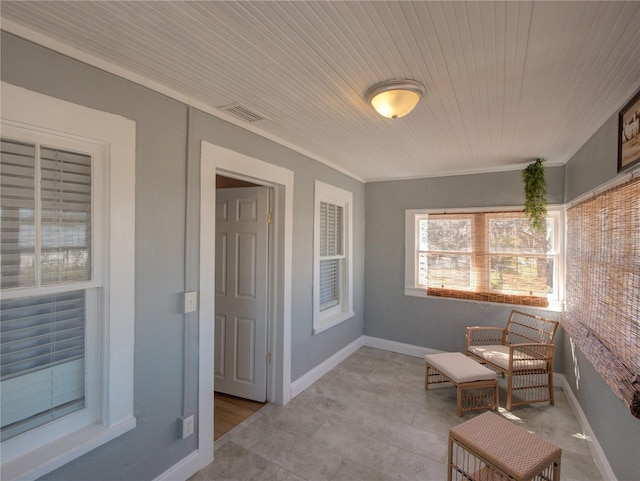 living area featuring wooden ceiling, visible vents, crown molding, and baseboards