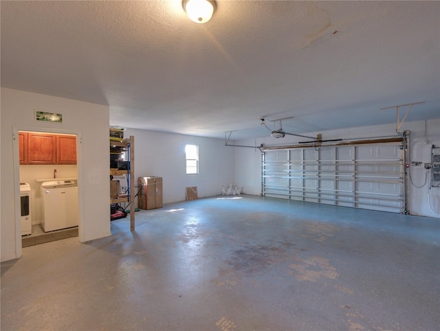 garage featuring independent washer and dryer and a garage door opener