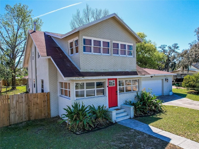 view of front of house featuring a garage, concrete driveway, fence, a front yard, and brick siding