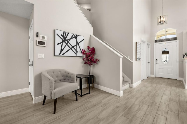 entrance foyer with wood tiled floor, stairway, and baseboards