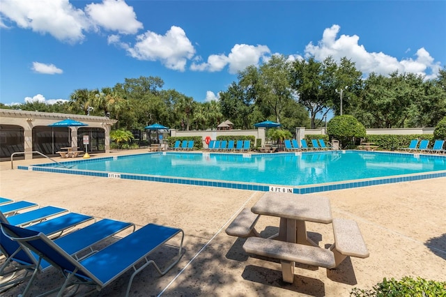 pool featuring a patio area and a pergola