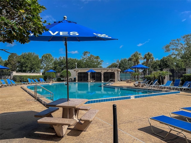 pool featuring a patio area and fence