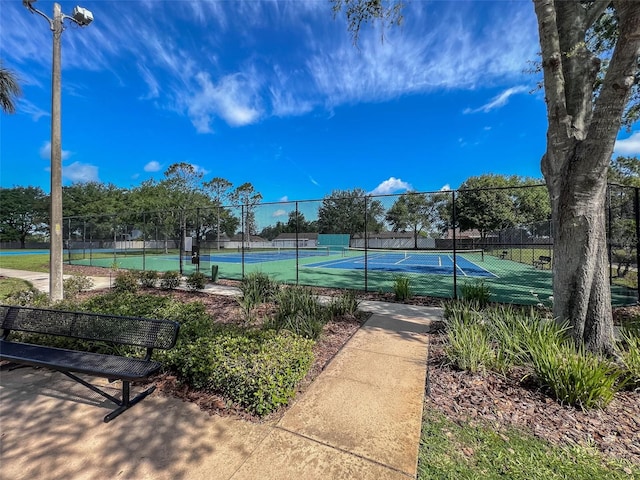 view of sport court featuring fence