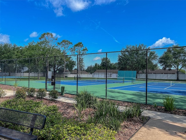 view of tennis court with fence