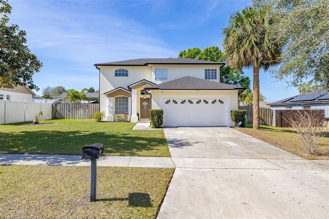 traditional-style home featuring a front yard, concrete driveway, fence, and an attached garage