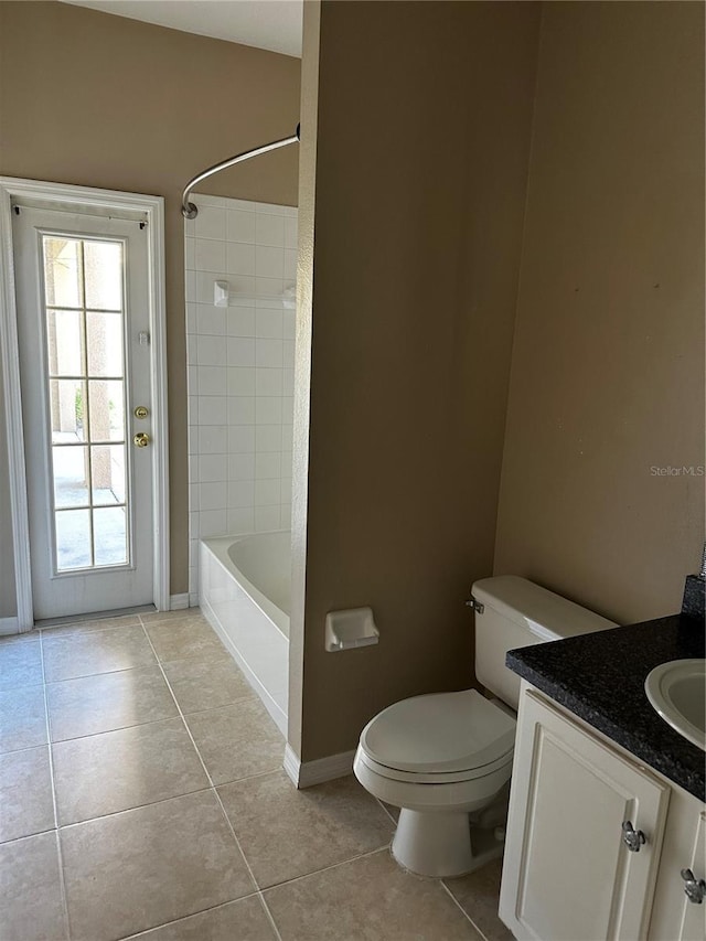 full bathroom with toilet, vanity, baseboards, tub / shower combination, and tile patterned floors