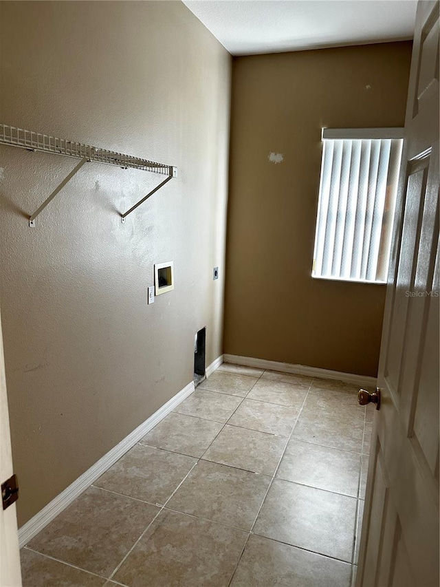 laundry area with laundry area, baseboards, hookup for a washing machine, tile patterned flooring, and hookup for an electric dryer