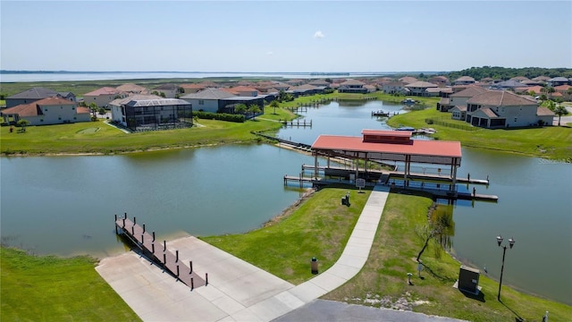 drone / aerial view featuring a water view and a residential view