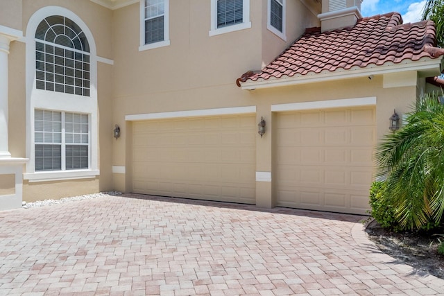 garage with decorative driveway