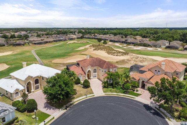 drone / aerial view with view of golf course and a residential view