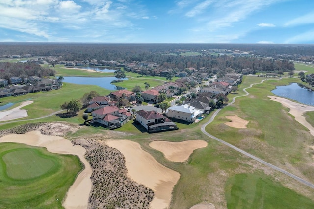 aerial view featuring golf course view and a water view