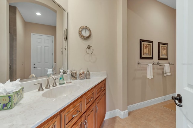 bathroom with baseboards, vanity, and tile patterned floors