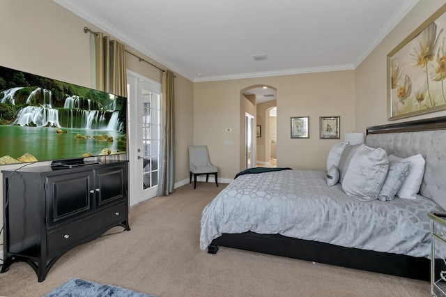 bedroom featuring ornamental molding, arched walkways, and light carpet