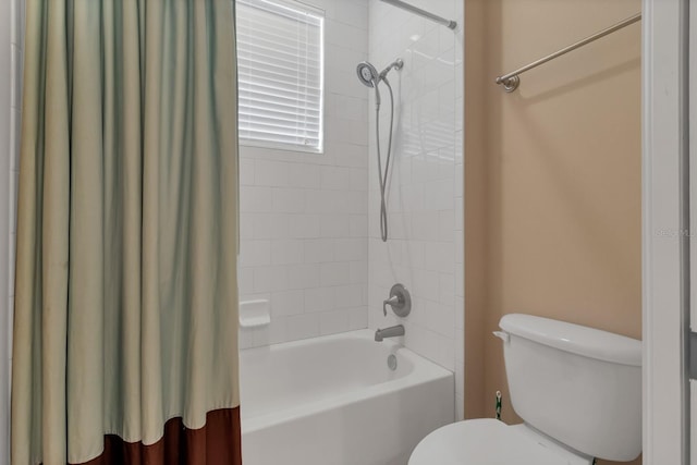 full bathroom featuring toilet and shower / bathtub combination with curtain