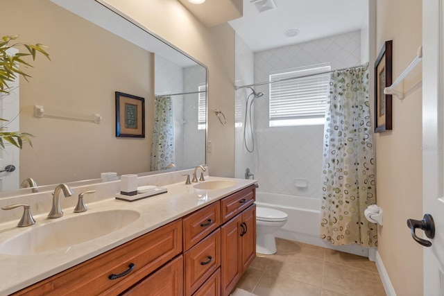 full bath featuring shower / tub combo with curtain, tile patterned flooring, visible vents, and a sink