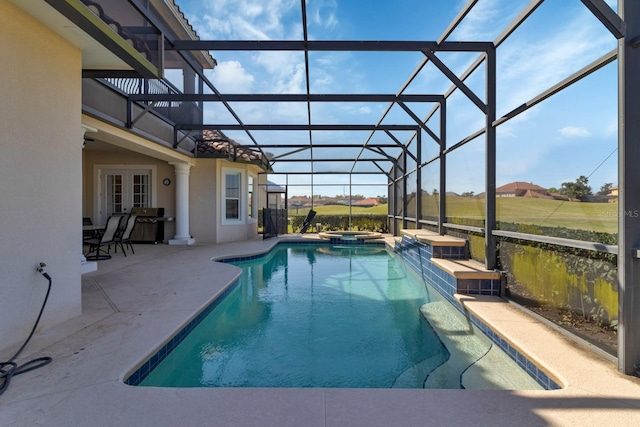 view of pool with glass enclosure, a pool with connected hot tub, french doors, and a patio