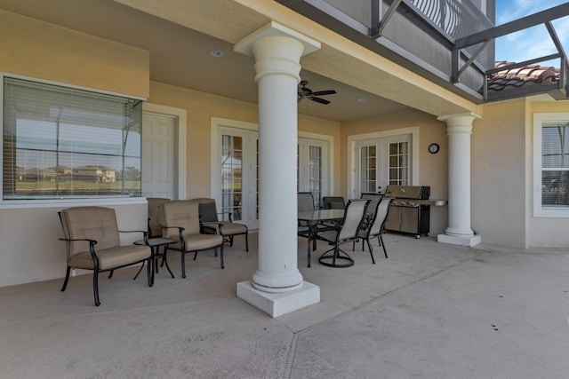 view of patio featuring ceiling fan, outdoor dining space, grilling area, and a lanai