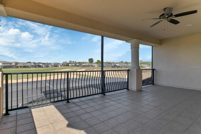 view of patio / terrace featuring ceiling fan, a residential view, and a balcony