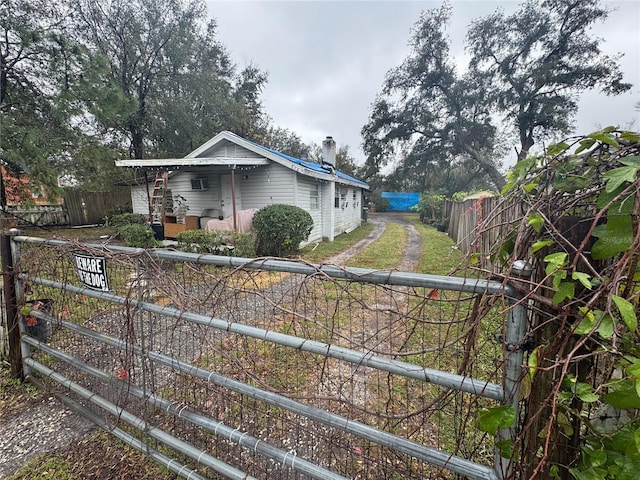 view of front facade featuring fence private yard and a chimney