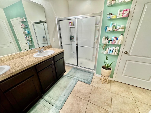 3082 Royal Tern Dr, Winter Haven, FL 33881 - bathroom featuring a stall shower, double vanity, and tile patterned flooring