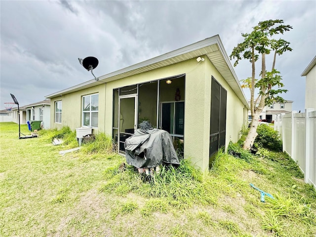 3082 Royal Tern Dr, Winter Haven, FL 33881 - rear view of house with stucco siding and a sunroom