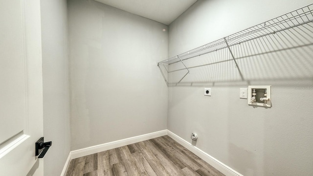 laundry area featuring hookup for a washing machine, hookup for an electric dryer, laundry area, wood finished floors, and baseboards