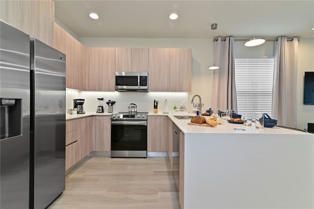 kitchen with stainless steel appliances, modern cabinets, and light brown cabinetry