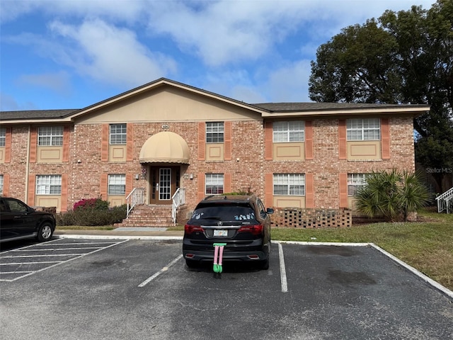 view of property featuring uncovered parking