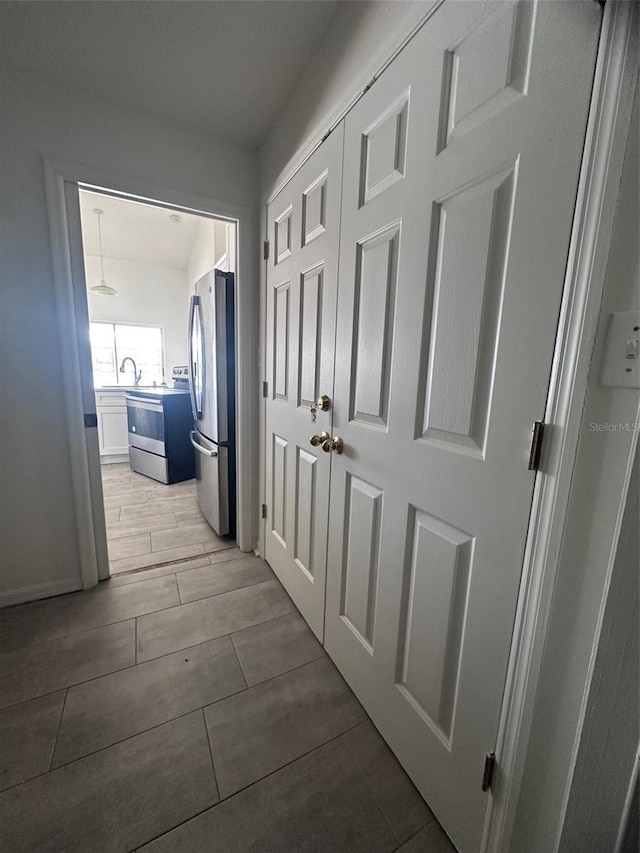 hallway featuring a sink and wood tiled floor