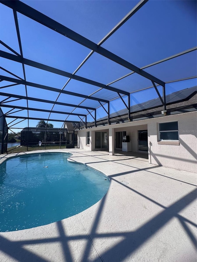 outdoor pool featuring a lanai and a patio