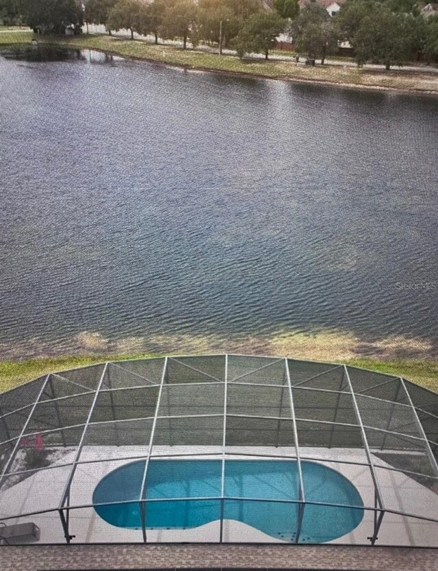 outdoor pool featuring a water view and a lanai