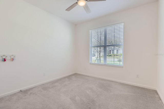 unfurnished room featuring ceiling fan, carpet, and baseboards