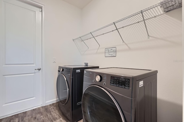 washroom with laundry area, visible vents, baseboards, dark wood-type flooring, and washer and dryer