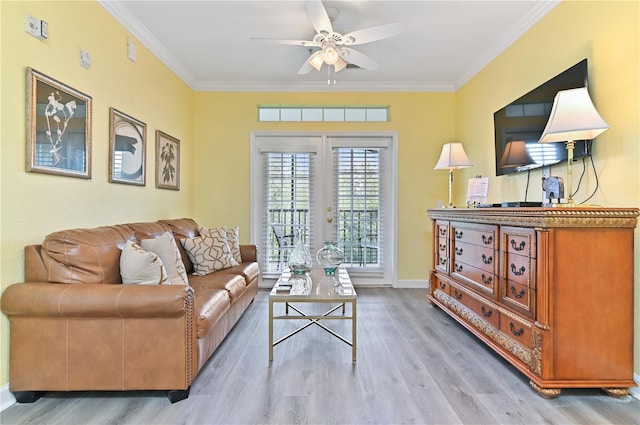 living area with light wood-type flooring, ceiling fan, and crown molding