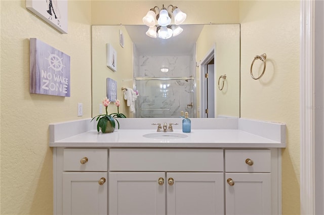 bathroom with a marble finish shower and vanity