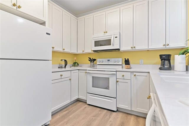 kitchen featuring white appliances, white cabinetry, light countertops, and light wood-style floors