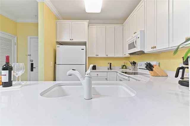 kitchen with crown molding, light countertops, white cabinetry, a sink, and white appliances