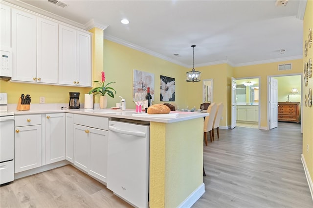 kitchen with visible vents, light wood-style flooring, ornamental molding, white appliances, and a peninsula