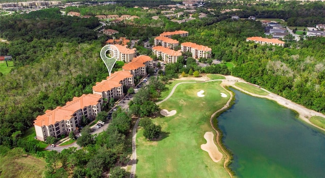 drone / aerial view featuring a water view and a view of trees