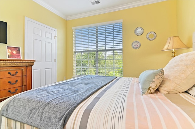 bedroom with ornamental molding and visible vents