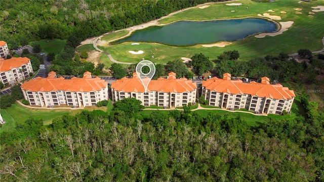 birds eye view of property with a water view and golf course view