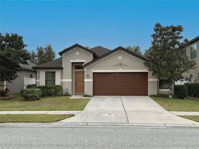 view of front of home with stucco siding, a shingled roof, an attached garage, a front yard, and driveway