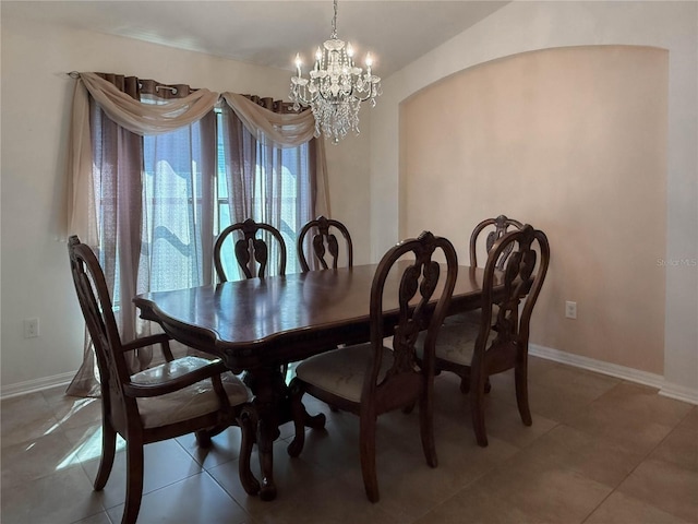 dining room featuring light tile patterned floors, baseboards, and a chandelier