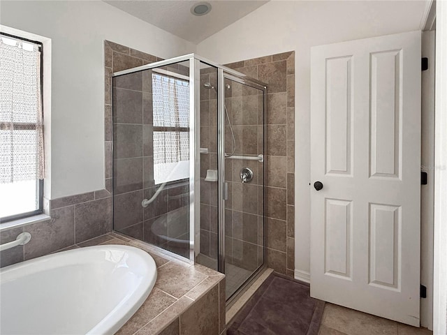 full bathroom featuring a stall shower, tile patterned flooring, and a bath