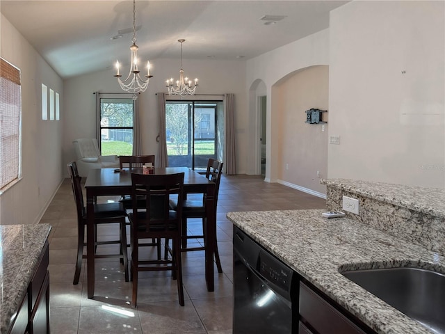 dining space with lofted ceiling, light tile patterned floors, arched walkways, a notable chandelier, and baseboards