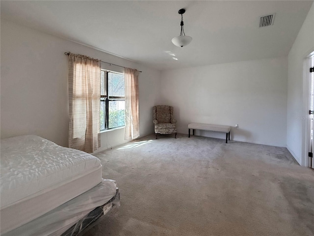 carpeted bedroom featuring visible vents