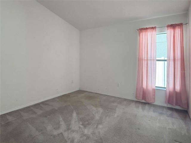 empty room with carpet and baseboards