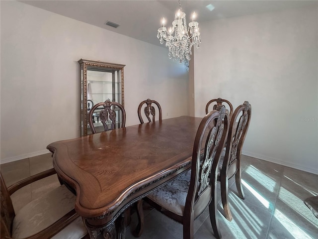 tiled dining space featuring a chandelier, visible vents, and baseboards