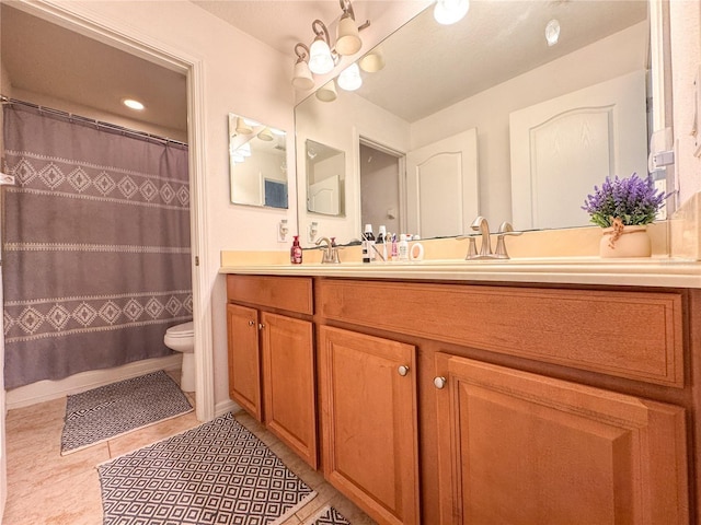 full bath with tile patterned flooring, a sink, toilet, and double vanity