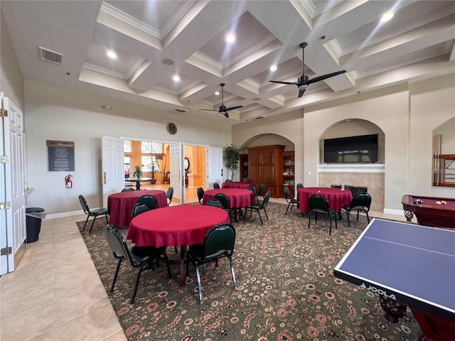 dining space featuring a high ceiling, coffered ceiling, visible vents, a ceiling fan, and beamed ceiling